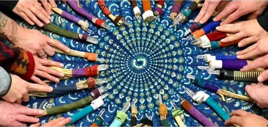 Colorful paint tubes arranged in a spiral pattern on a blue surface.