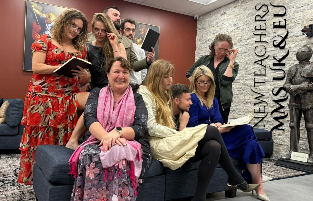 Group of people sitting and reading in a cozy indoor setting.
